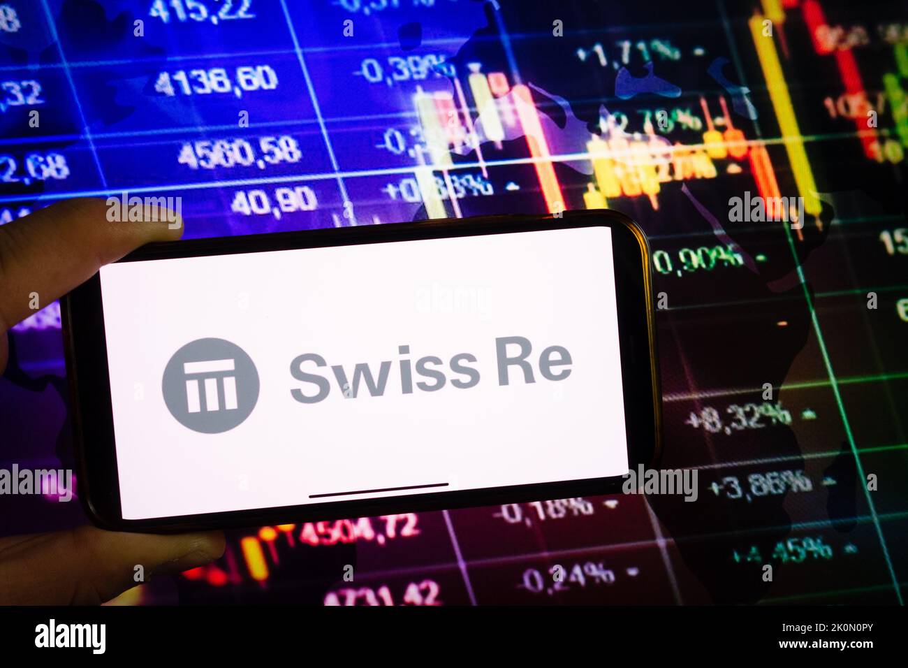 KONSKIE, POLAND - September 10, 2022: Smartphone displaying logo of Swiss Re company on stock exchange diagram background Stock Photo