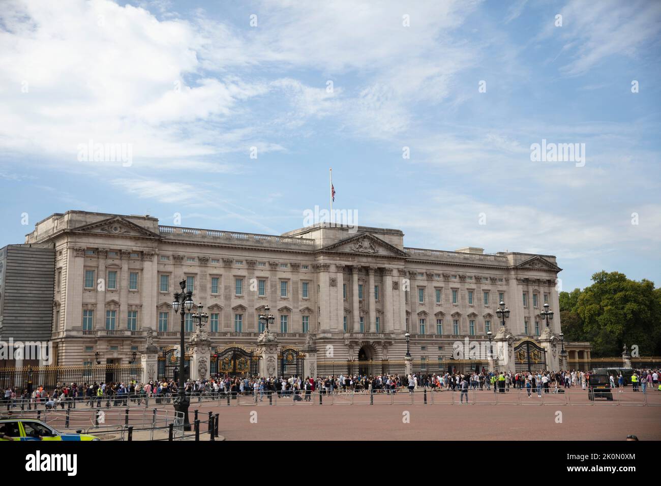 LONDON, UK - September 2022: People make their way to Buckingham Palace to pay tribute to Queen Elizabeth II after her death Stock Photo