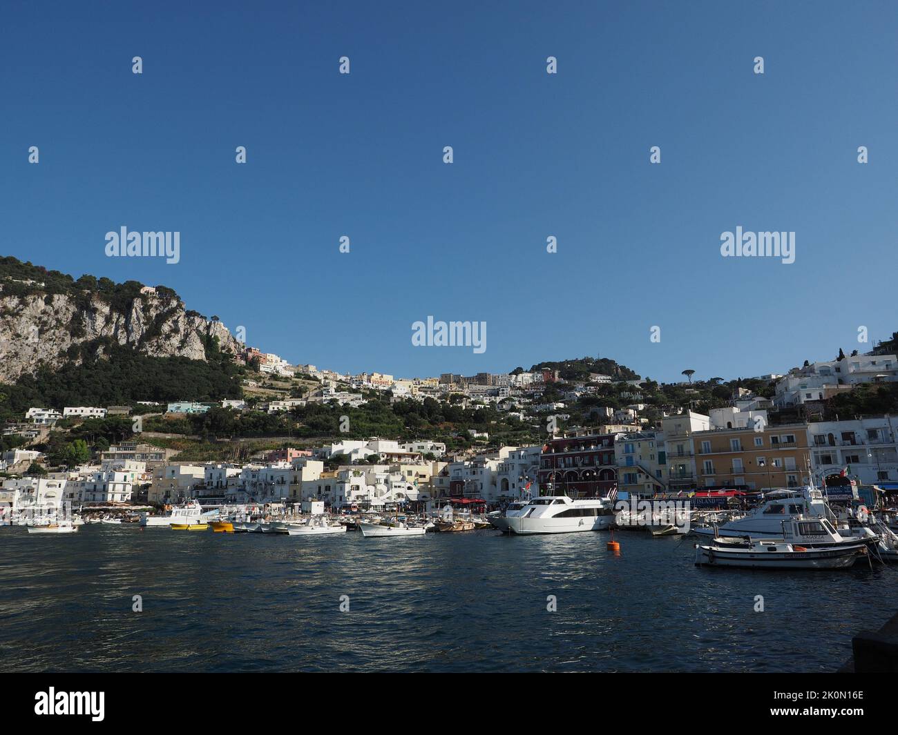 The port of Capri Island; the main town can be seen on top of the hills. Capri, Campania, Italy Stock Photo