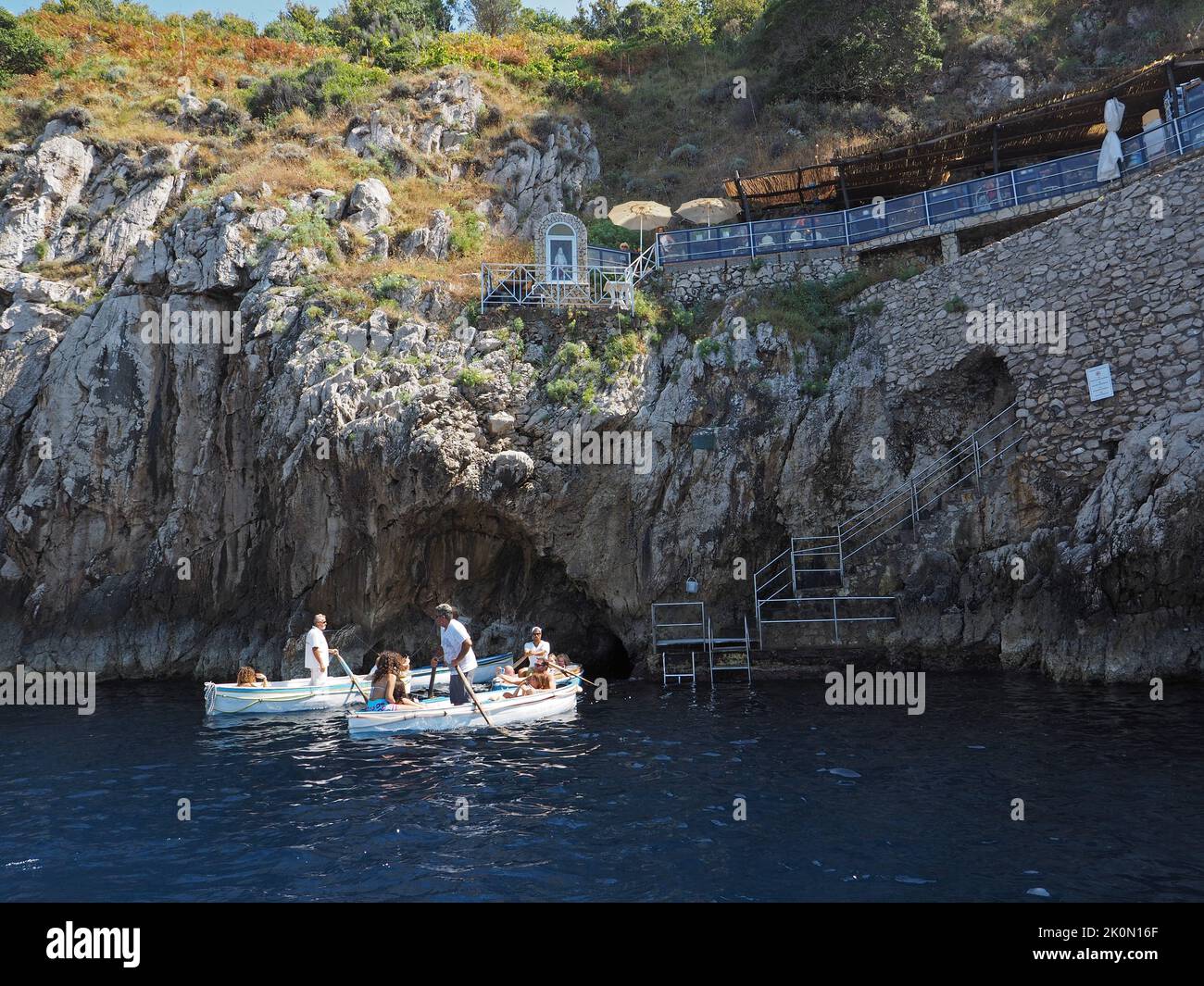 Entrance to the blue grotto on Capri island. The entrance is so small you can only get in lying on the floor of special narrow rowing boats. Capri, IT Stock Photo