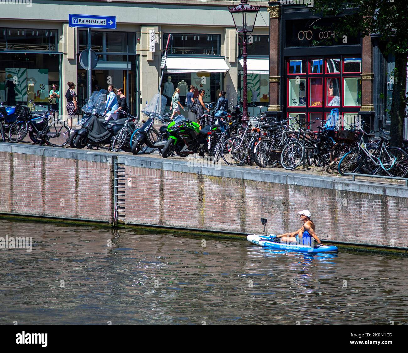 Man on a kayak on an Amsterdam canal Stock Photo