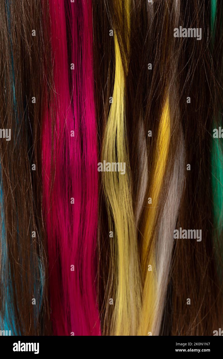 Fake colorful hair wig on brunette head close up view Stock Photo