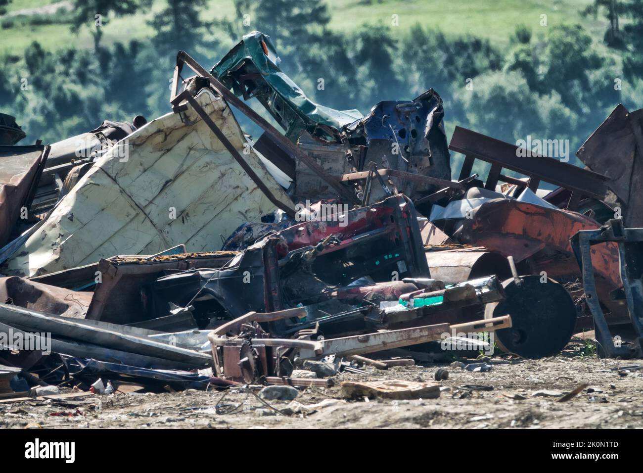 A mountain of scrap metal in the mountains. Pollution of nature by