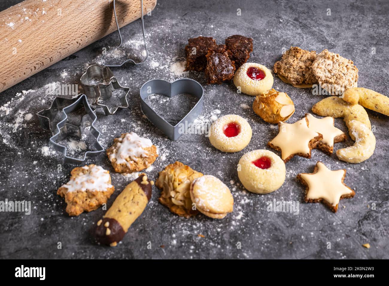 Christmas treats, freshly baked Christmas biscuits with baking utensils Stock Photo