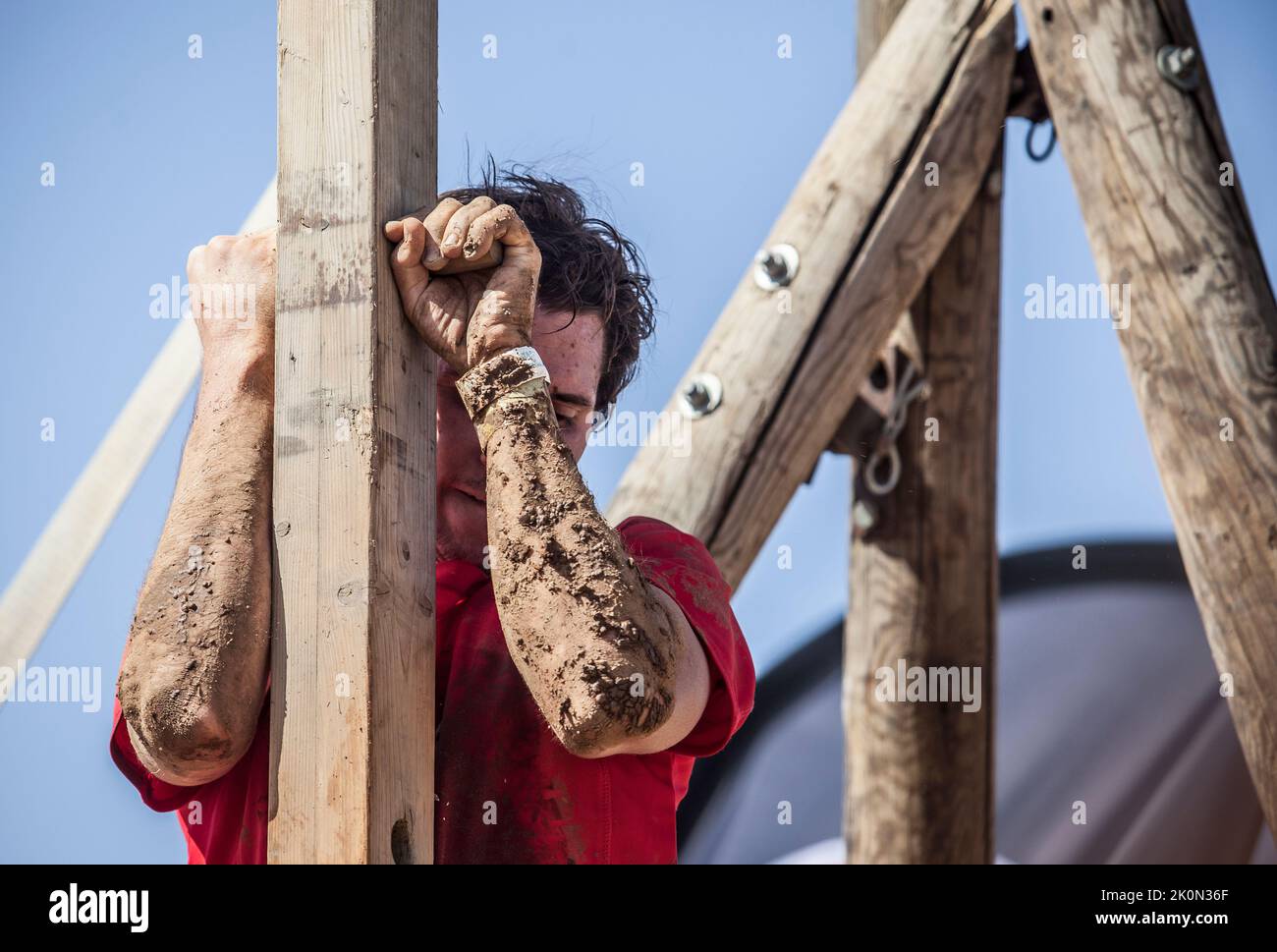 Merida, Spain - Sept 11th, 2022: FarinatoRace Merida 2022. Toughest obstacle course in the world. Climbing up a wooden beam with spikes Stock Photo