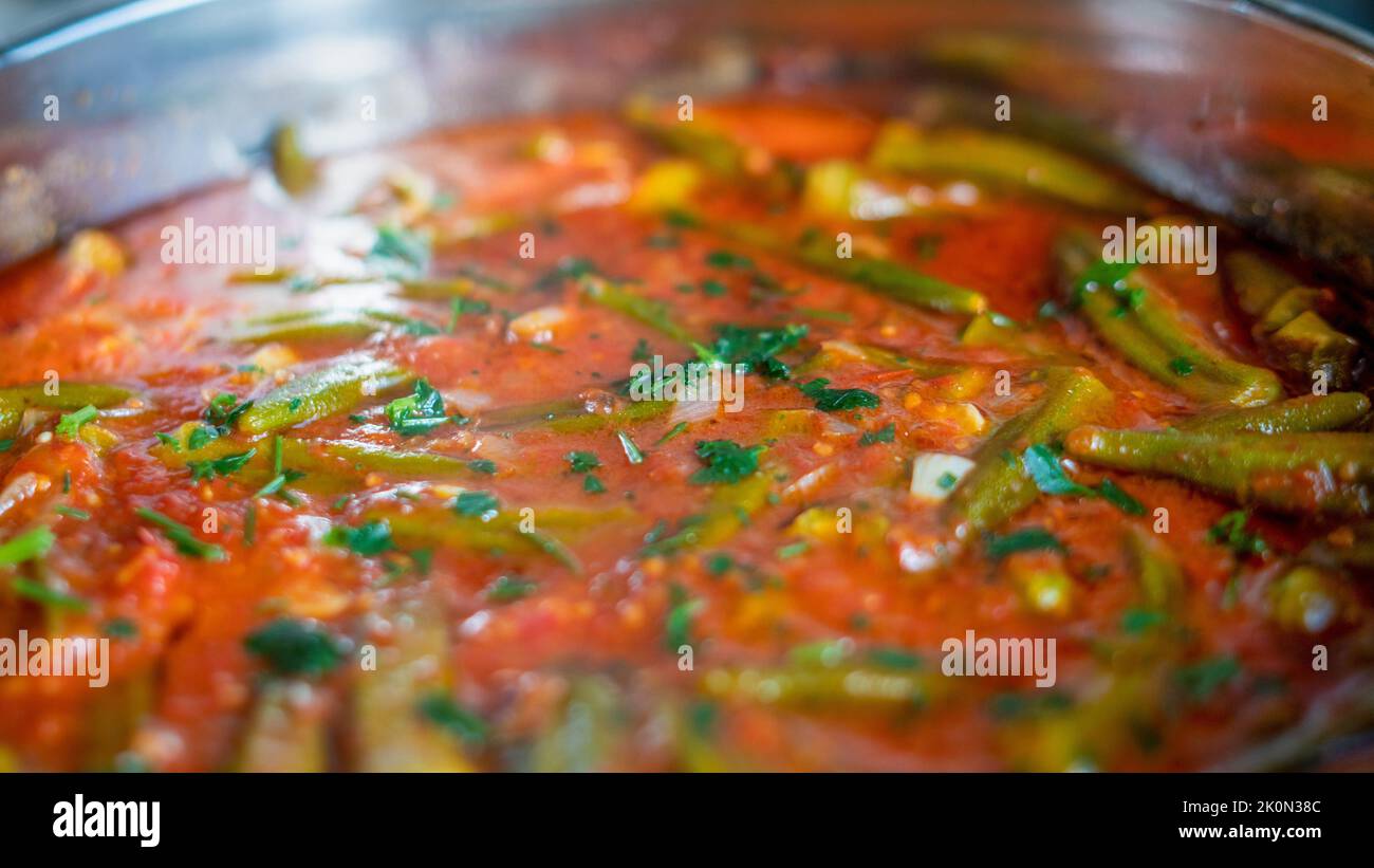 Top view of stewed okra (known as gumbo or ladies' fingers) main dish. Turkish traditional Ramadan food. Stock Photo