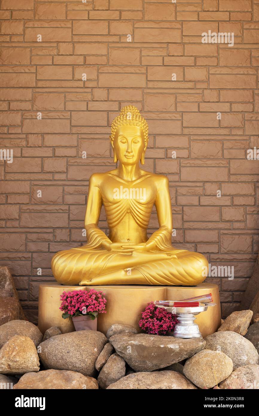 A thin, fasting gold Buddha statue in a temple at Watt Munisotaram Cambodian Buddhist Monastery in Hampton, Minnesota. Stock Photo
