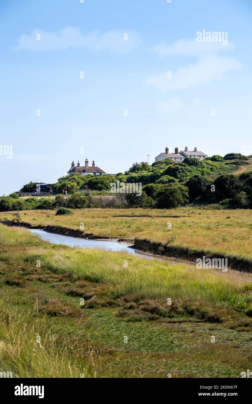 SEAFORD, ENGLAND - JULY 9th, 2022: View of the river Cuckmere and the coastgard cottages in summer, East Sussex, England Stock Photo