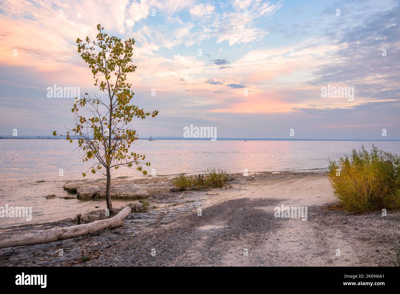 Majestic autumn sunset over an empty beach on a lake in autumn. Lake Eire, Canada. Stock Photo