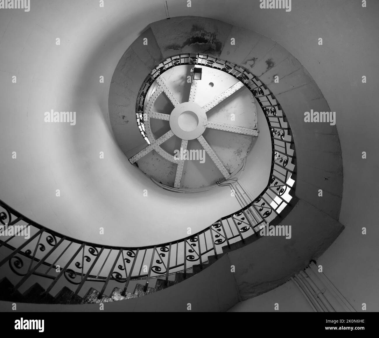 Monochrome image of the spiral staircase inside old Dungeness lighthouse, Kent, England. Stock Photo