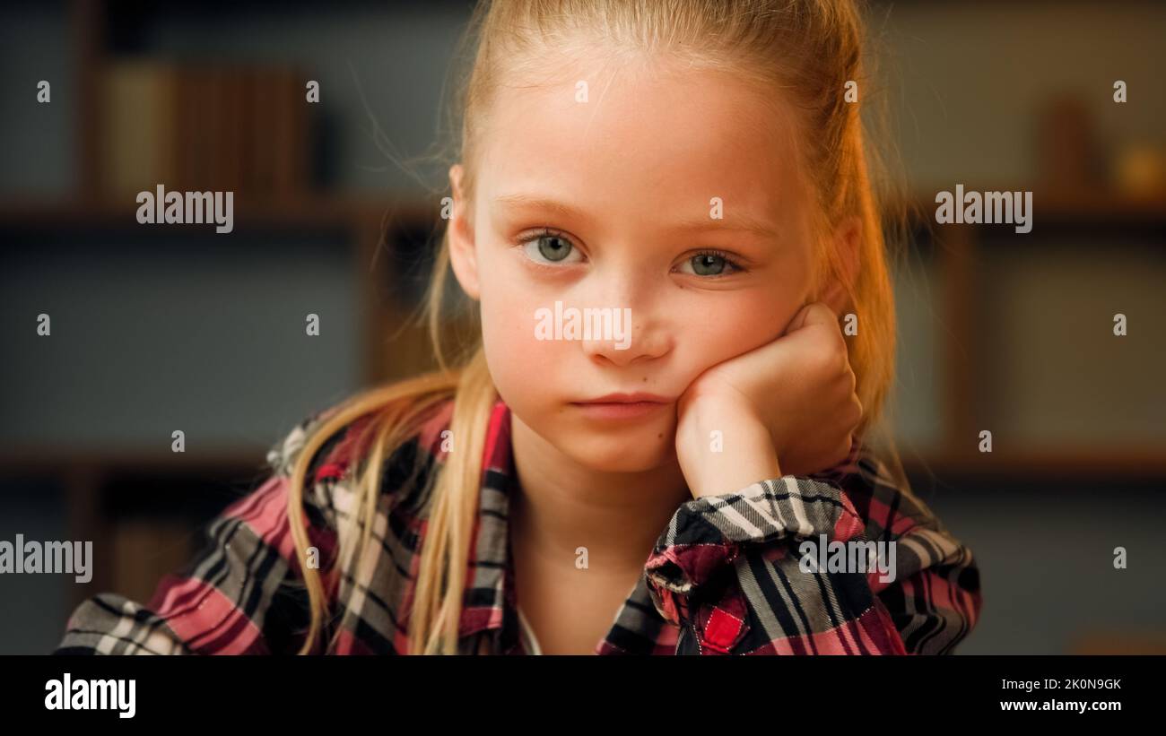 Close up portrait little offended child sad upset bored preschool girl pretty blonde female kid look at camera sit at home alone sweety daughter feel Stock Photo