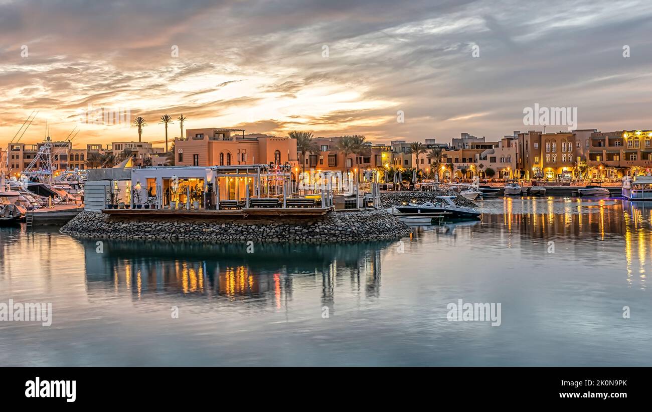 Restaurant in Abu Tig Marina at sunset with the lights reflecting in the water, El Gouna, Egypt, January 14, 2021 Stock Photo