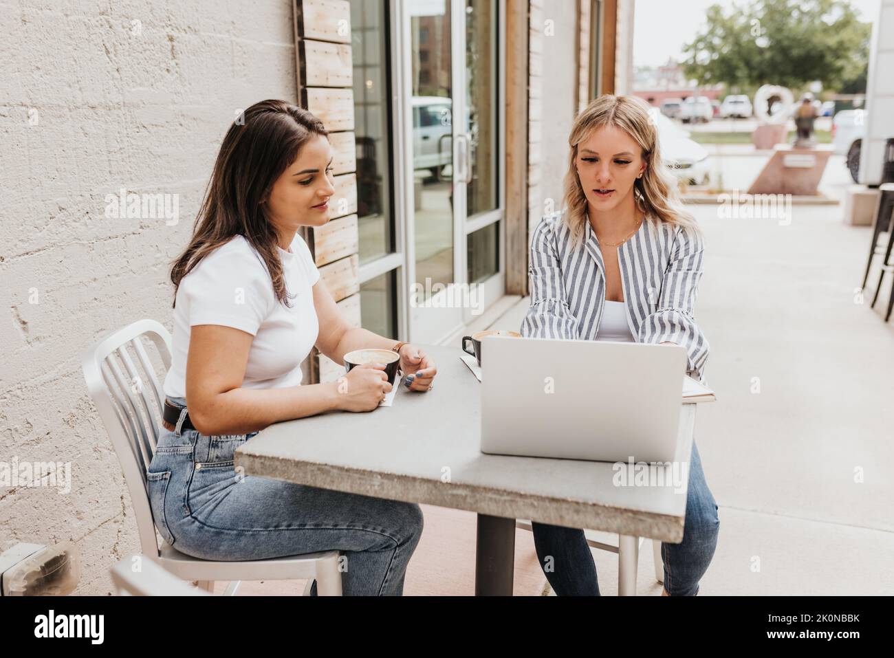 Two young professional females work together during meeting Stock Photo