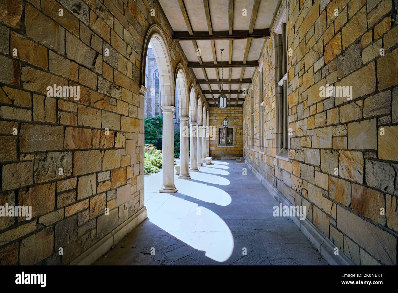 Gothic cloister type passageway beside a university building Stock Photo