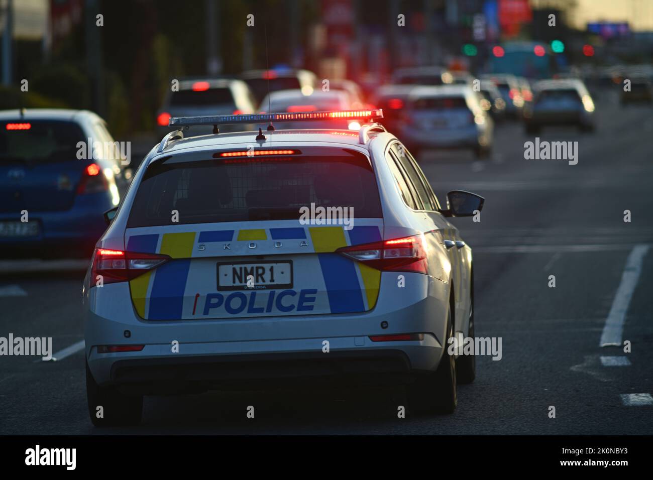 CHRISTCHURCH, NEW ZEALAND, AUGUST 30, 2022: A police car weaves through peak hour traffic on Moorhouse Avenue with its siren wailing and lights flashing. Stock Photo