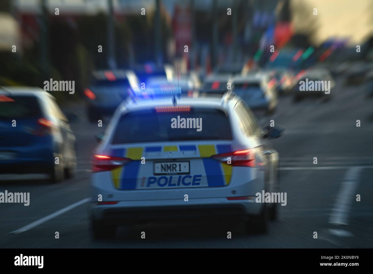 CHRISTCHURCH, NEW ZEALAND, AUGUST 30, 2022: A police car weaves through peak hour traffic on Moorhouse Avenue with its siren wailing and lights flashing. Stock Photo