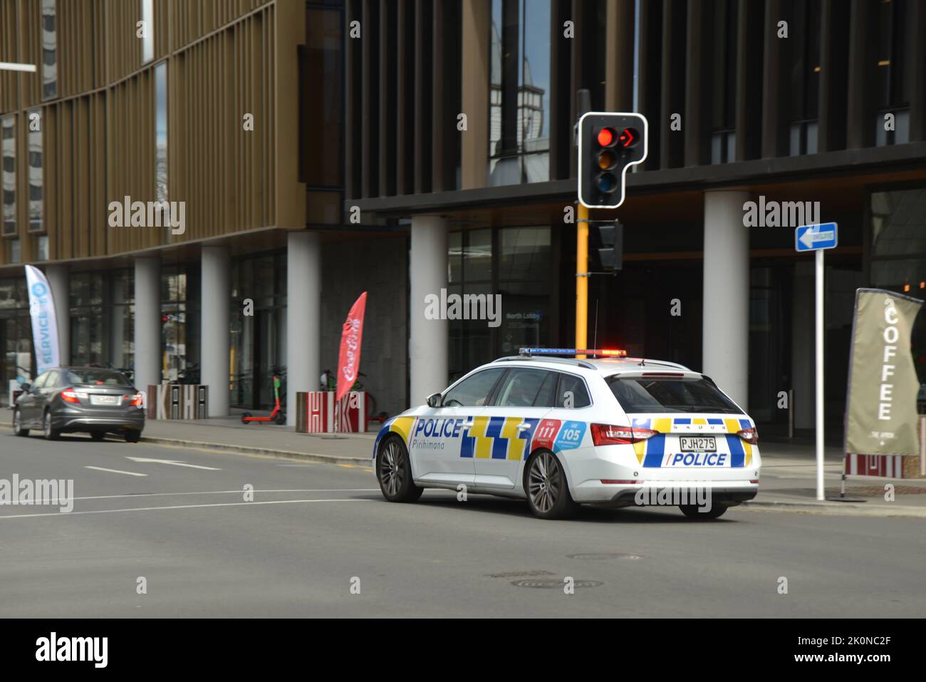 CHRISTCHURCH, NEW ZEALAND, SEPTEMBER 8, 2022: A police car with lights flashing and siren wailing runs a red light as it heads to an emergency in Christchurch Stock Photo