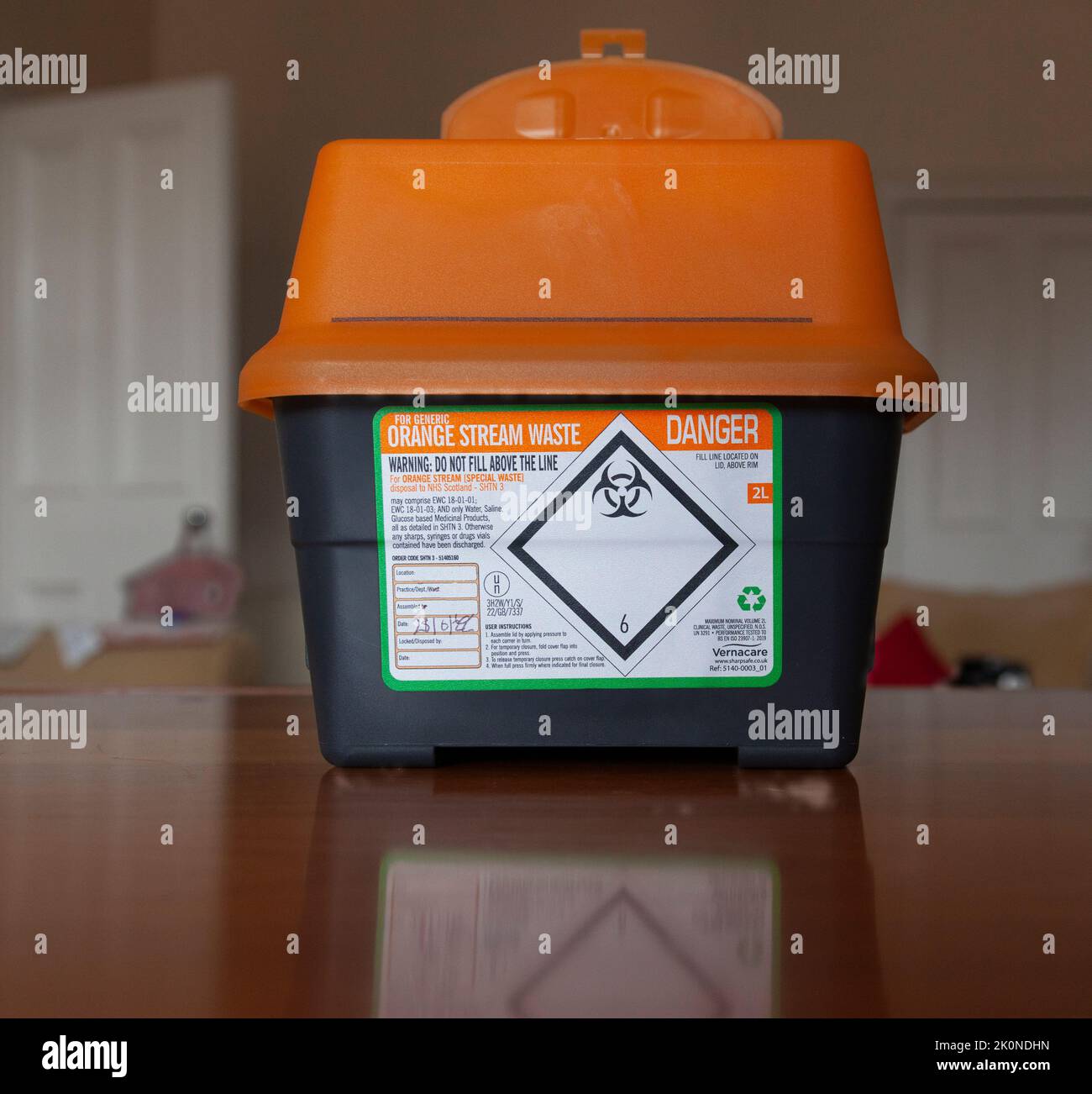Stock photo of a sharps disposal box "for generic orange stream waste