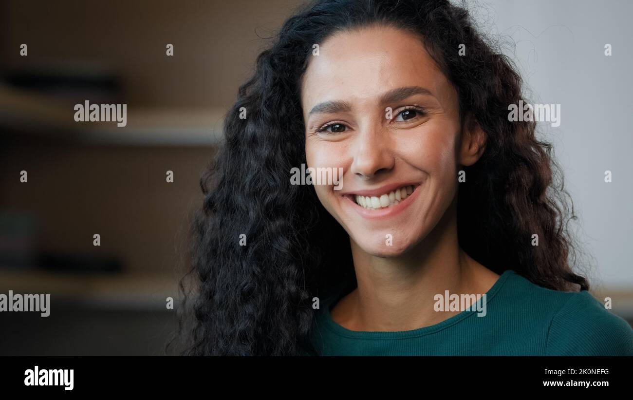 Close up headshot female portrait young sexy girl arabian hispanic student housewife beautiful gorgeous stylish woman with long curly hair perfect Stock Photo