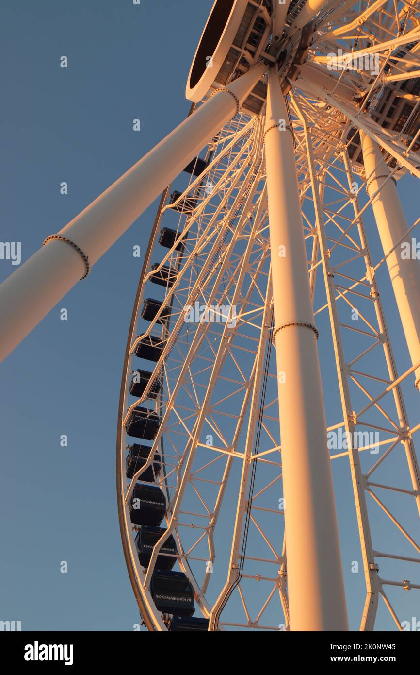 Millenium Wheel at Navy Pier caught against a blue winter sky and illuminated by the rising sun Stock Photo