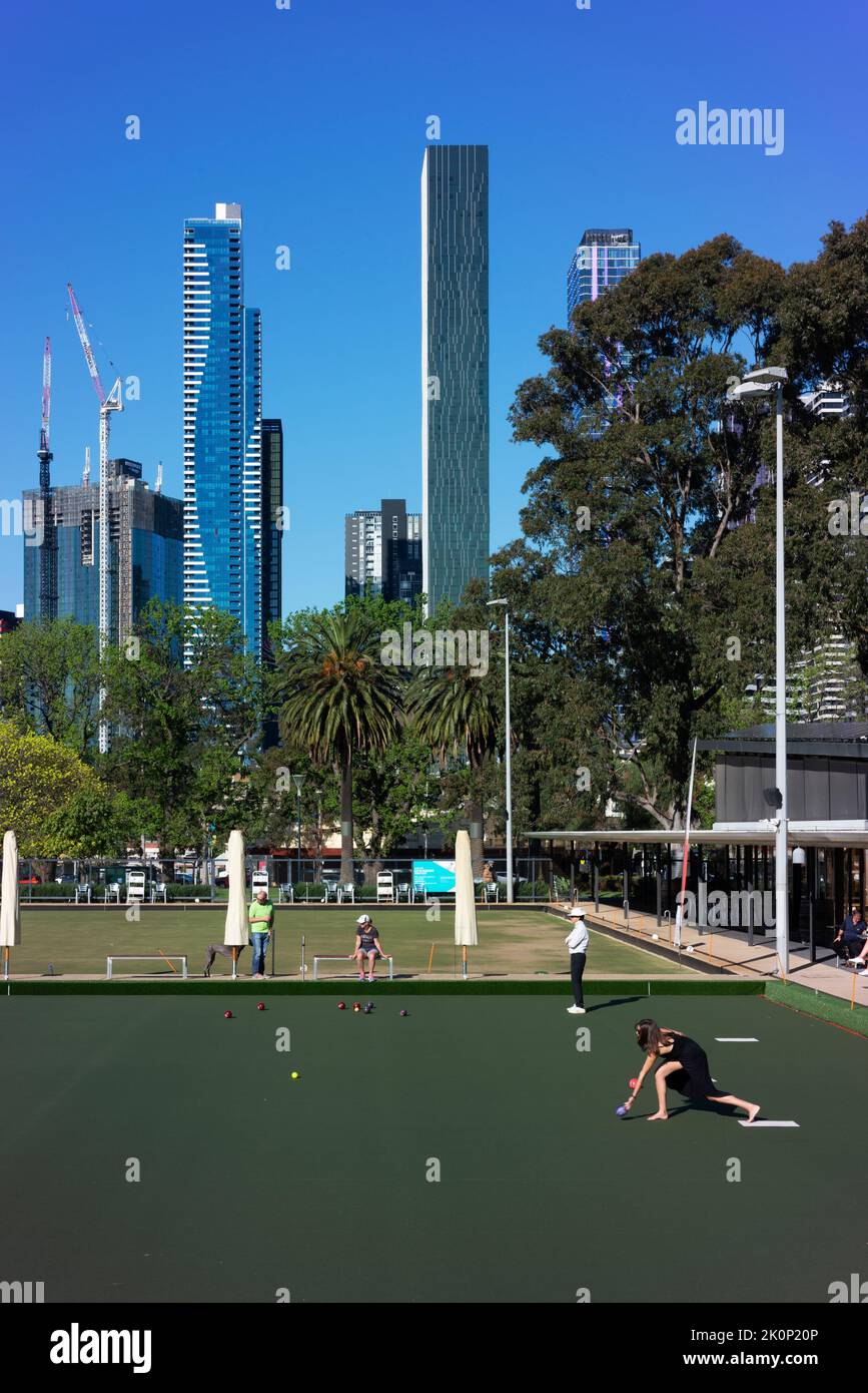 A young woman bowls at the City of Melbourne Bowls Club. Stock Photo