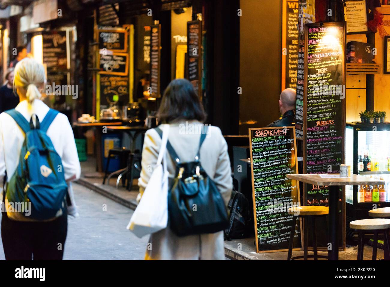 Two women walk through Centre Place in Melbourne's CBD, known for its cheap eateries.  It is one of Melbourne's famed laneways. Stock Photo