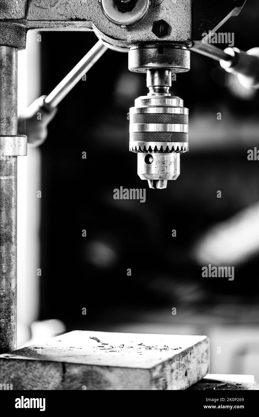 Industrial drill press with wooden board underneath Stock Photo Alamy