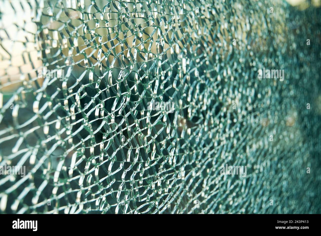 Cracked triplex glass window background. Closeup abstract backdrop Stock Photo