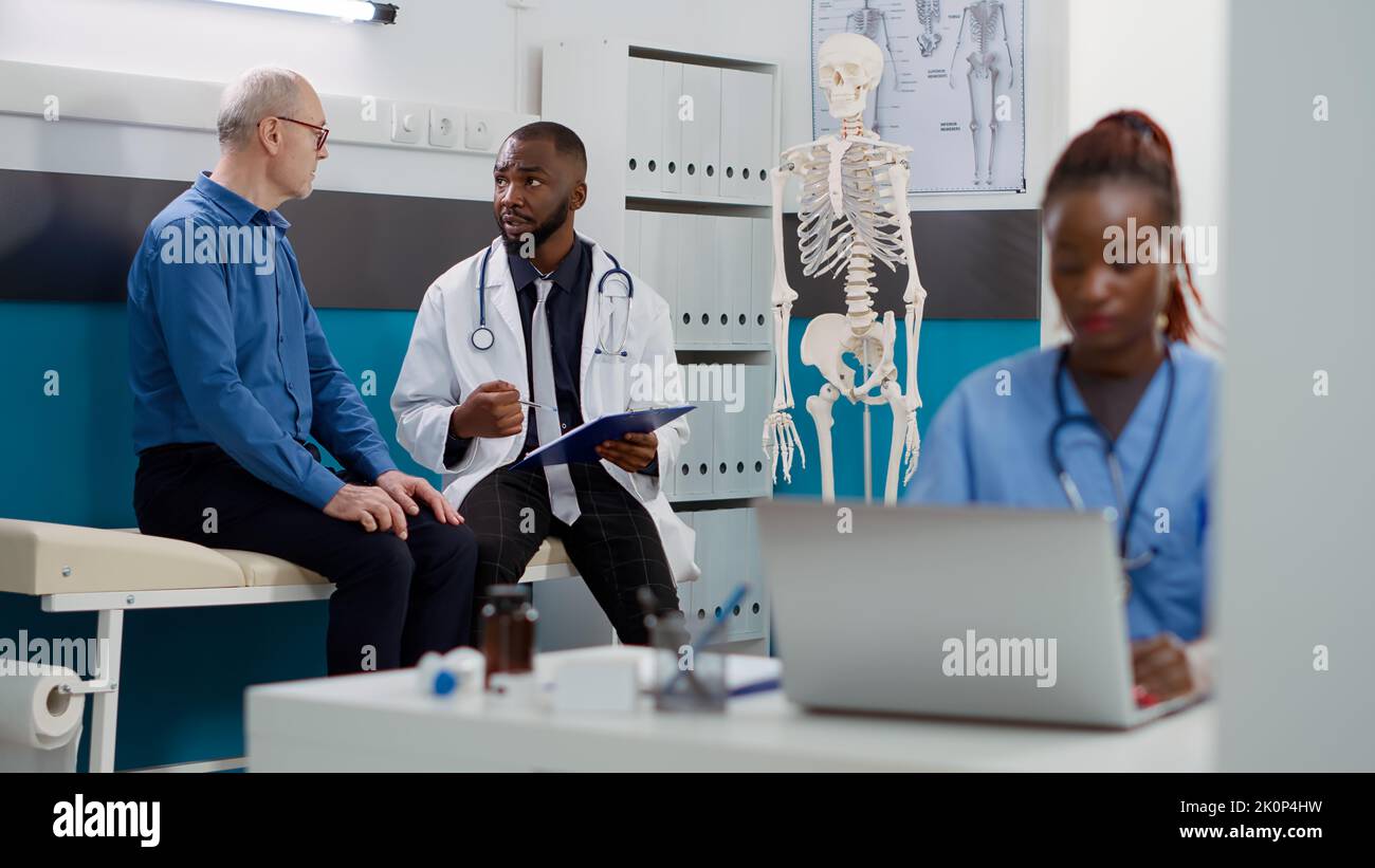 general-practitioner-consulting-senior-man-with-disease-at-checkup