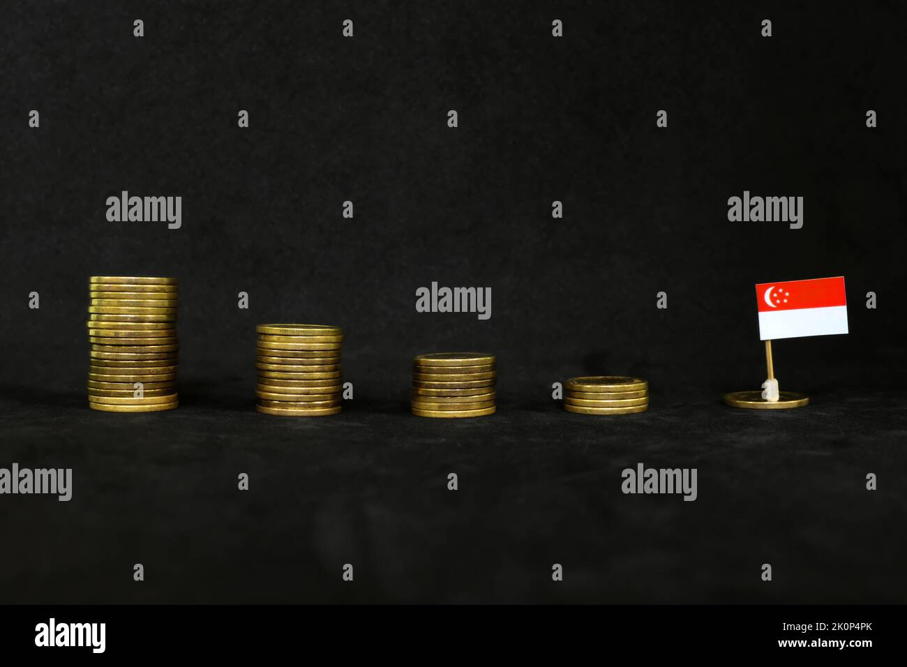 Singapore economic recession, financial crisis and currency depreciation concept. Singaporean flag in decreasing stack of coins in dark black Stock Photo