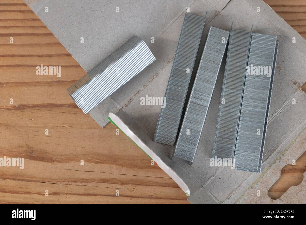 Metal staples for staple machine on woodenn background close up Stock