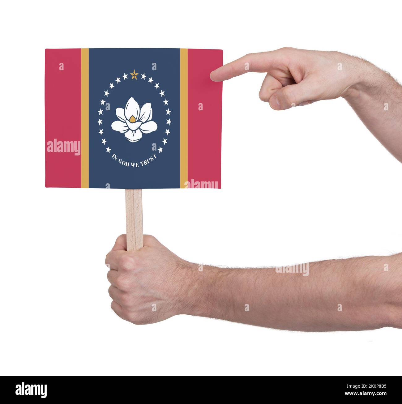 Hand holding banner on wood stick, isolated - Flag of Mississippi Stock Photo