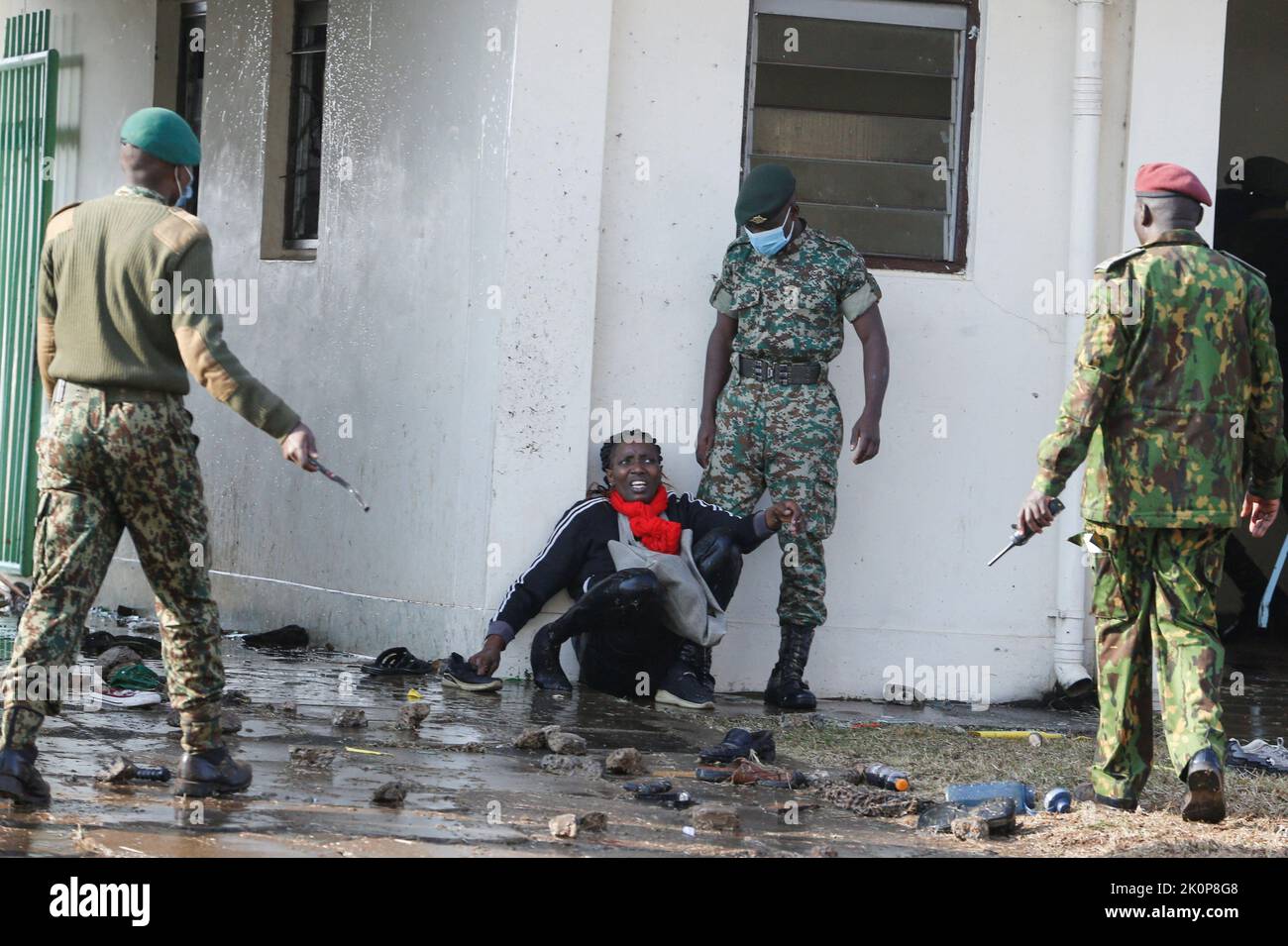Security officers look at a woman injured in a stampede as they attempt to control people jostling to attend the inauguration of Kenya's President William Ruto before his swearing-in ceremony at the Moi International Stadium Kasarani in Nairobi, Kenya September 13, 2022. REUTERS/Thomas Mukoya     TPX IMAGES OF THE DAY Stock Photo
