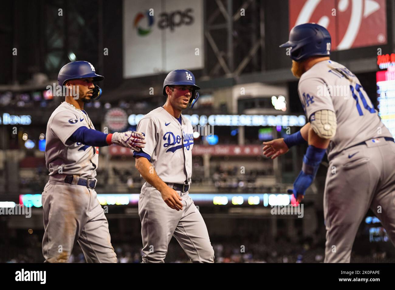 Los Angeles Dodgers left fielder Chris Taylor (3celebrates with second baseman Mookie Betts (50) and designates hitter Justin Turner (10) in the seven Stock Photo