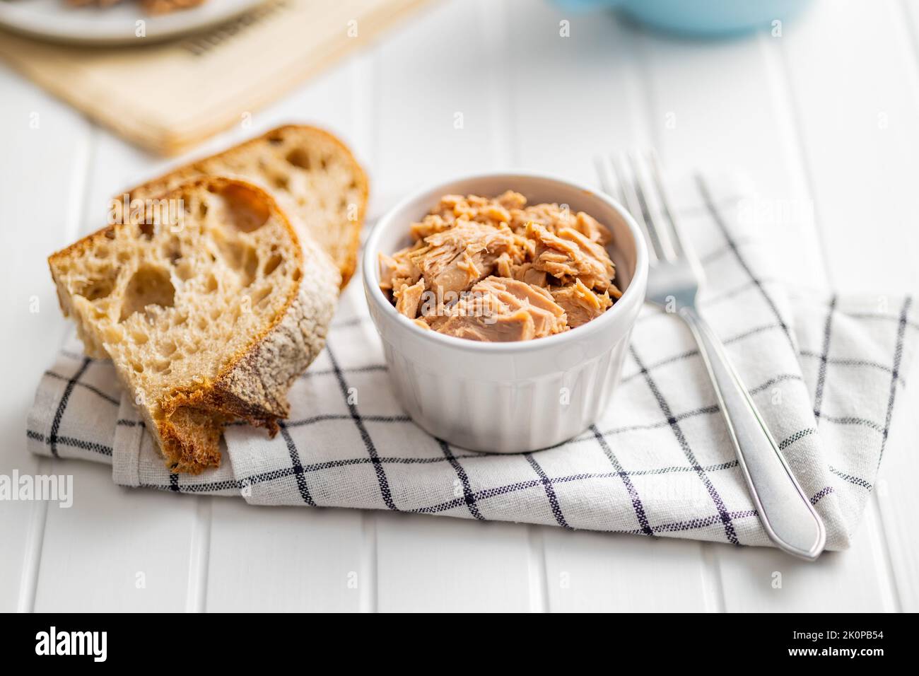 Canned tuna fish in the bowl on napkin. Stock Photo