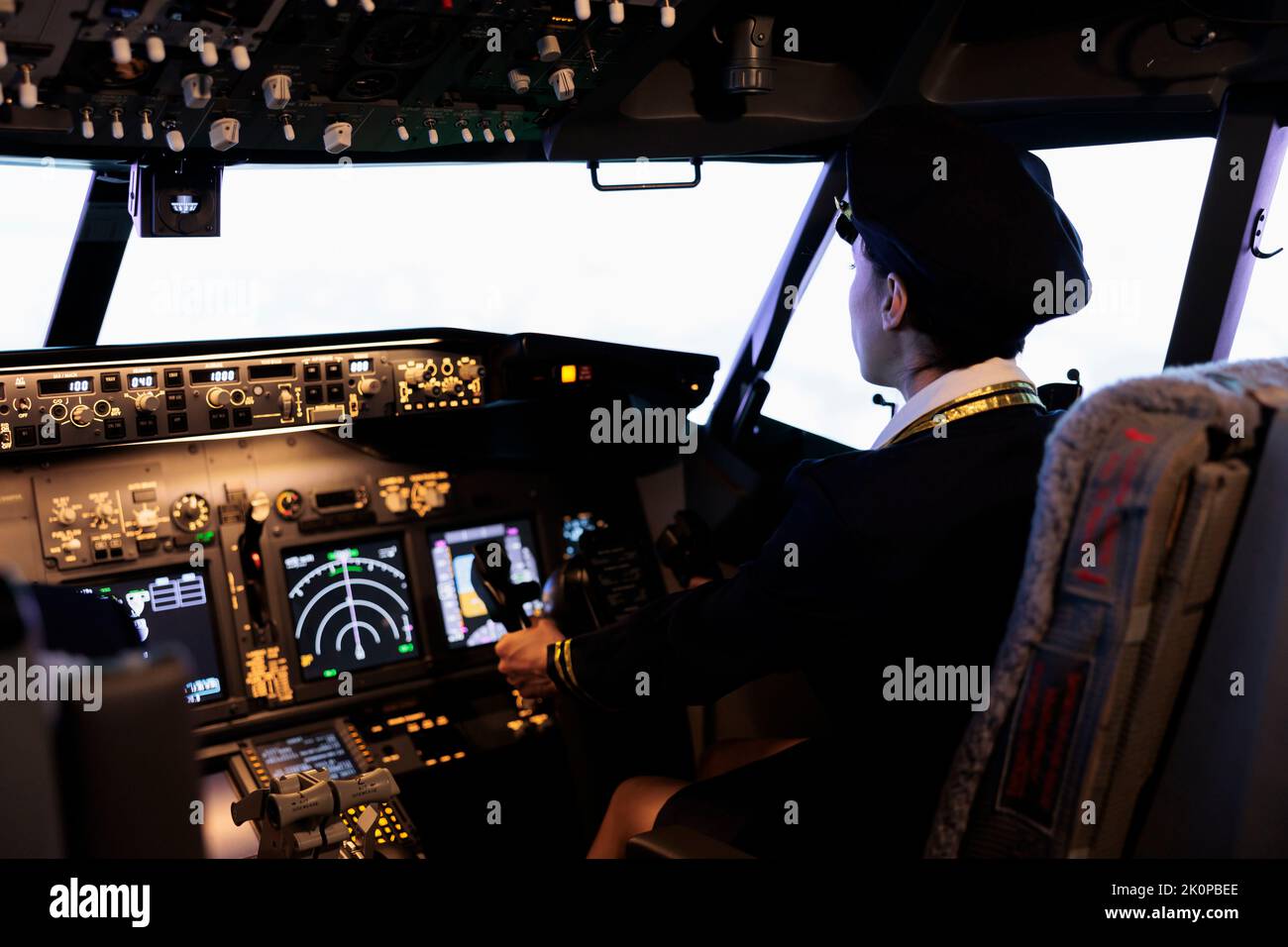 Copilot helping captain to fly airplane with cabin command and buttons on dashboard navigation. Piloting aircraft with radar compass, windscreen and control panel switch or lever. Stock Photo