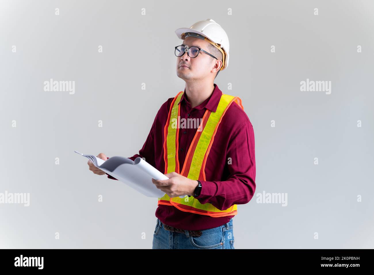 Architect builder studying layout plan of the rooms, civil engineer checking work with  blueprints in a studio. Architect, Engineer, Civil Concept of Stock Photo
