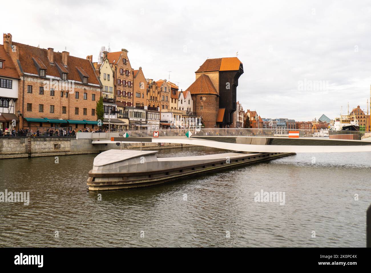 New modern bridge turning in Old town in Gdansk reflection in Moltawa