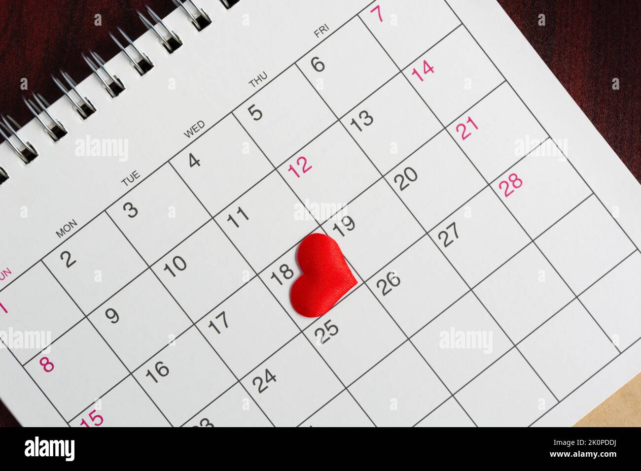 Red heart shape on the date of the 18th day in the calendar. Stock Photo