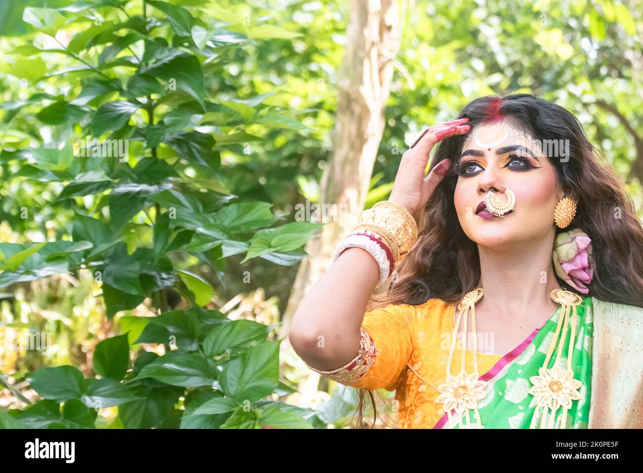 Portrait of beautiful Indian brunette woman faces  with traditional dress like goddess, this is a representative concept of Agomoni Stock Photo