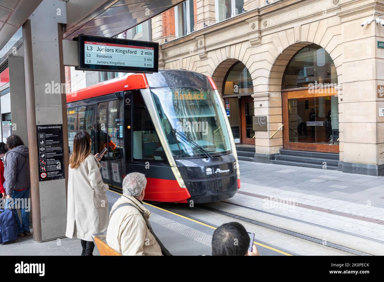 Passengers prepare to board Sydney light rail train at Bridge street station,Sydney city centre,NSW,Australia Stock Photo