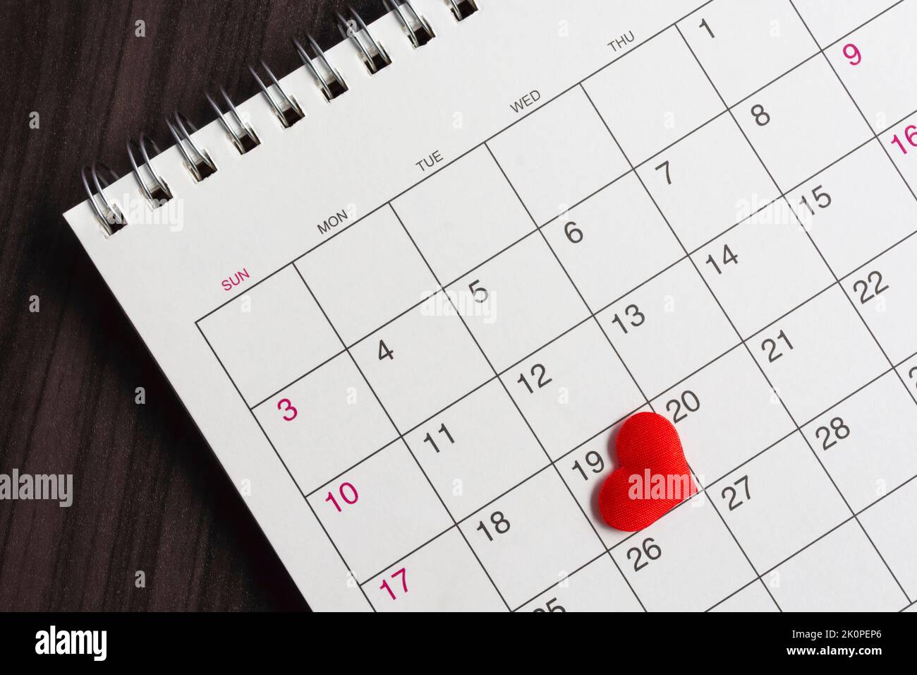 Red heart shape on the date of the 19th day in the calendar. Stock Photo
