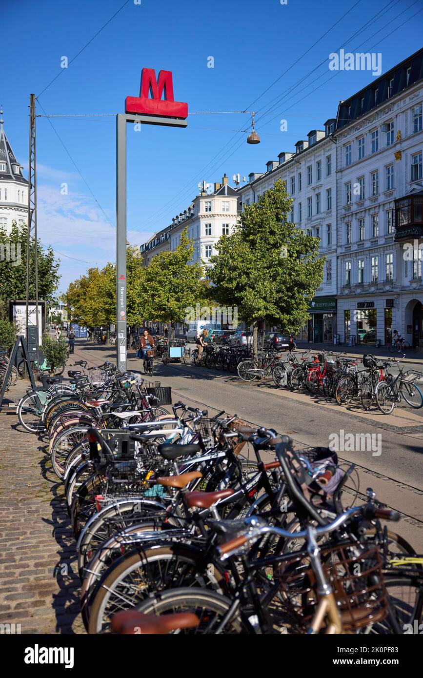 Metro sign, Nørreport Station, parked bikes in the foreground; Frederiksborggade Copenhagen, Denmark Stock Photo