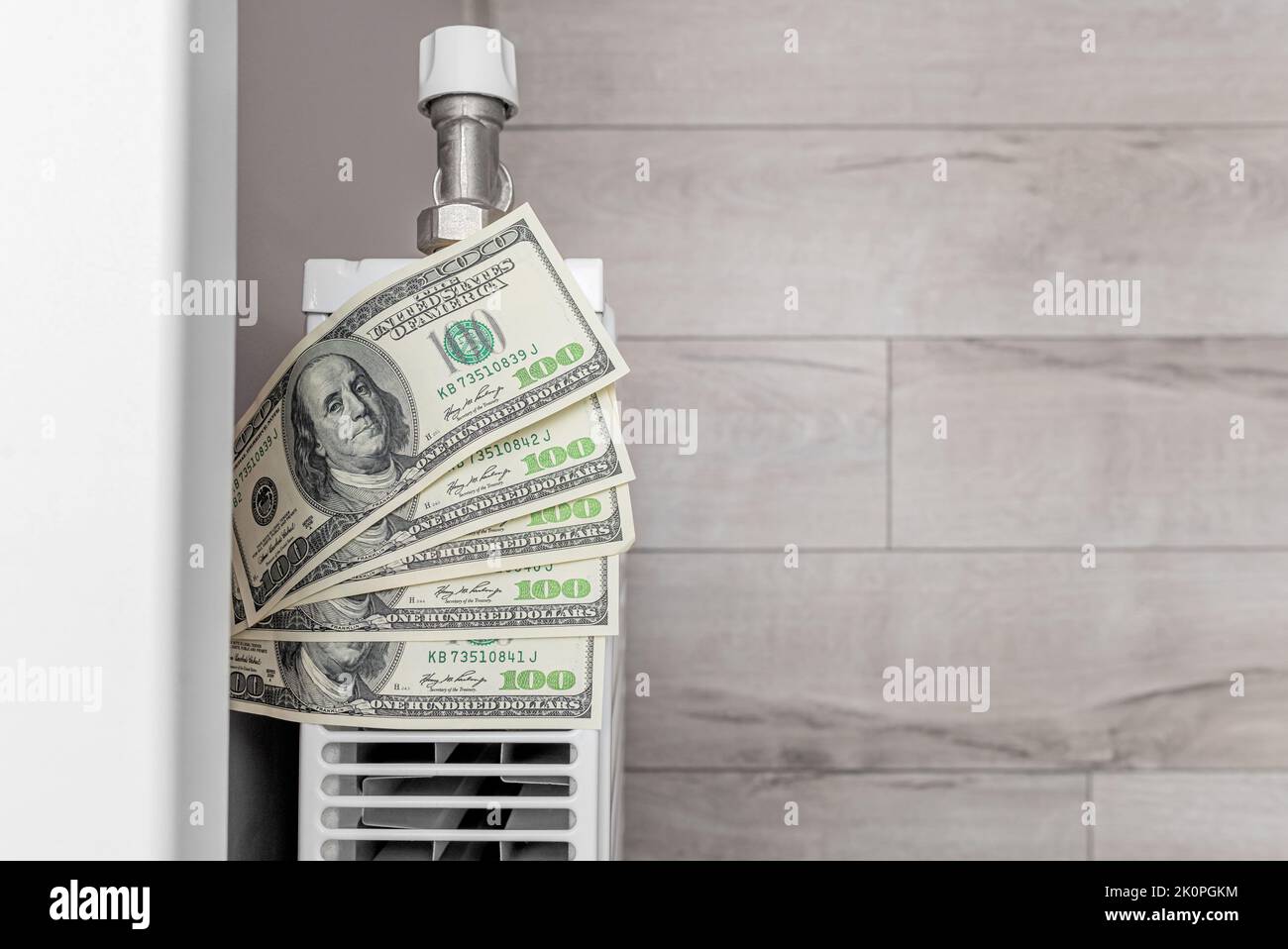 Dollars lie on the radiator. Stock Photo