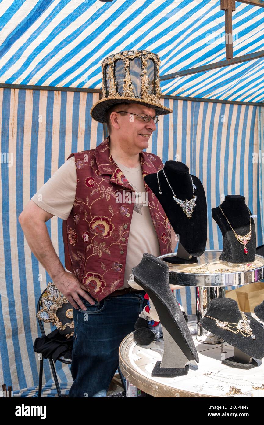 Stallholder in fancy top hat and waistcoat at Lincoln Steampunk Festival, Lincoln 2022 Stock Photo