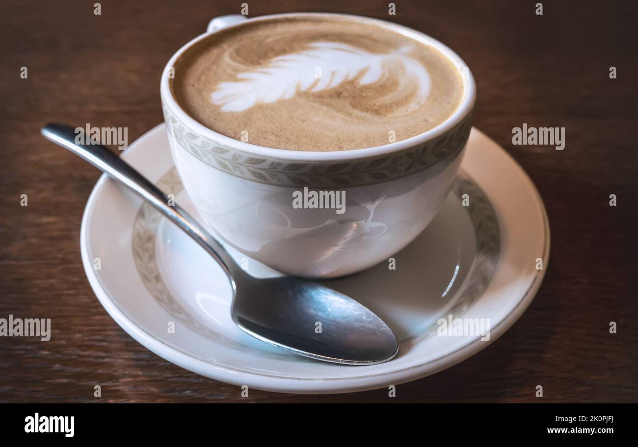 Cup of coffee latte on old wooden table, close up. Stock Photo