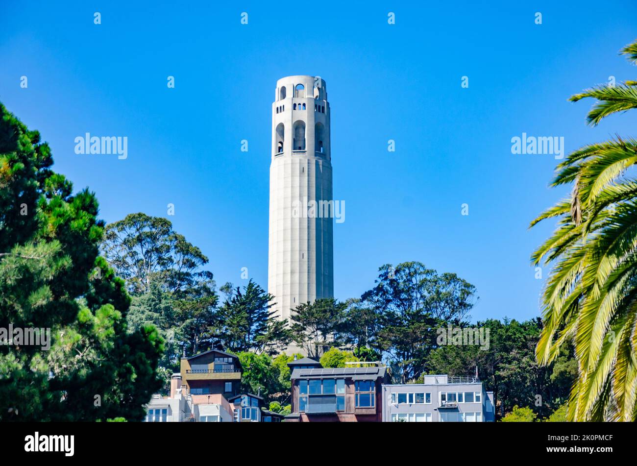 The Coit Tower, a white circular tower in San Francisco, California pictured against a clear blue sky. Stock Photo