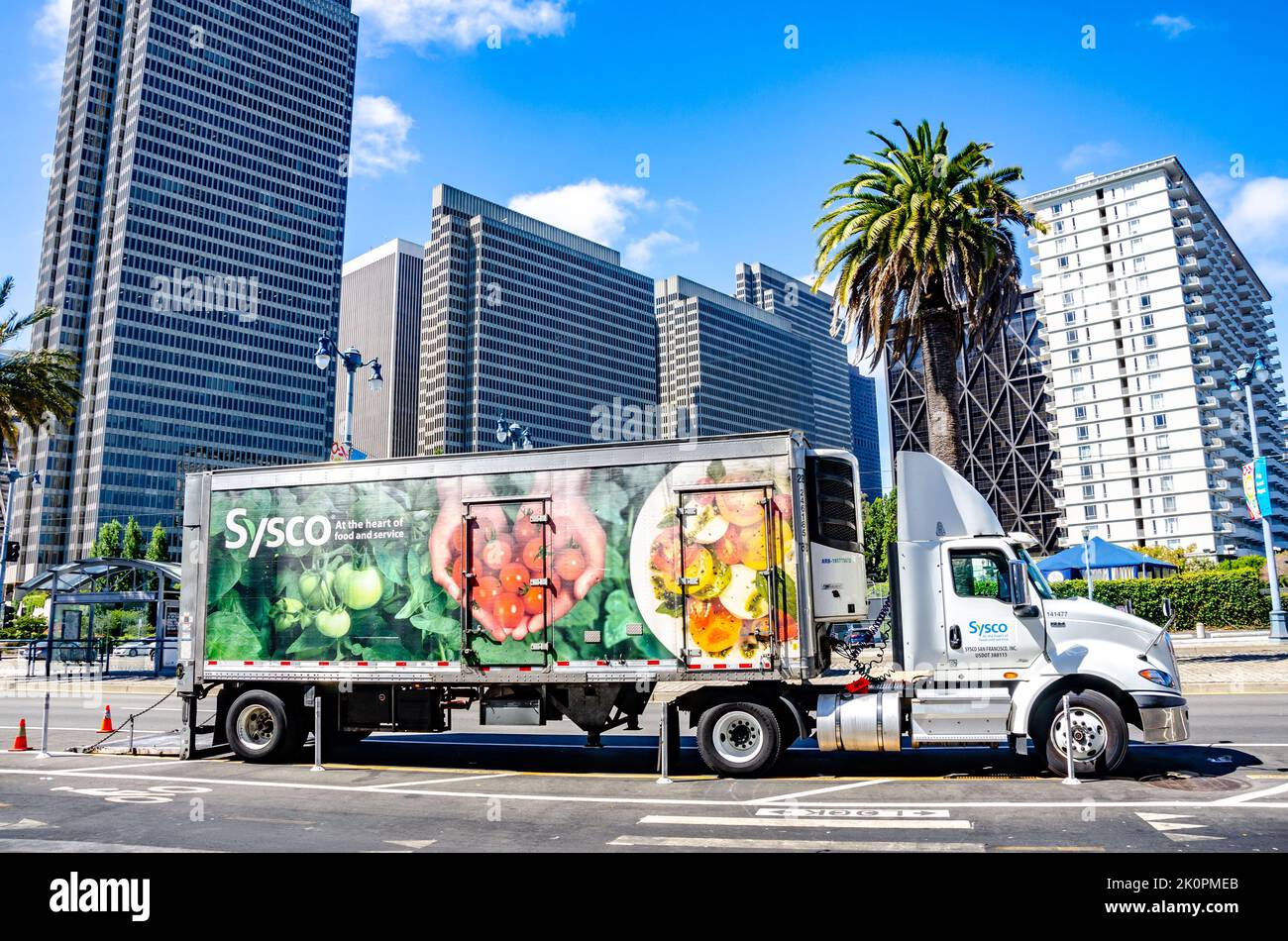 A Sysco delivery truck parked on Embarcadero in San Francisco in front of modern tower block on a summer's day Stock Photo