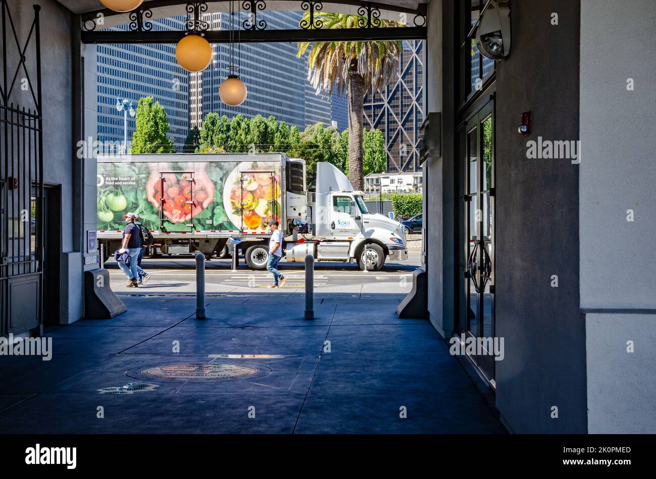 A Sysco delivery truck parked on Embarcadero in San Francisco in front of modern tower block on a summer's day Stock Photo