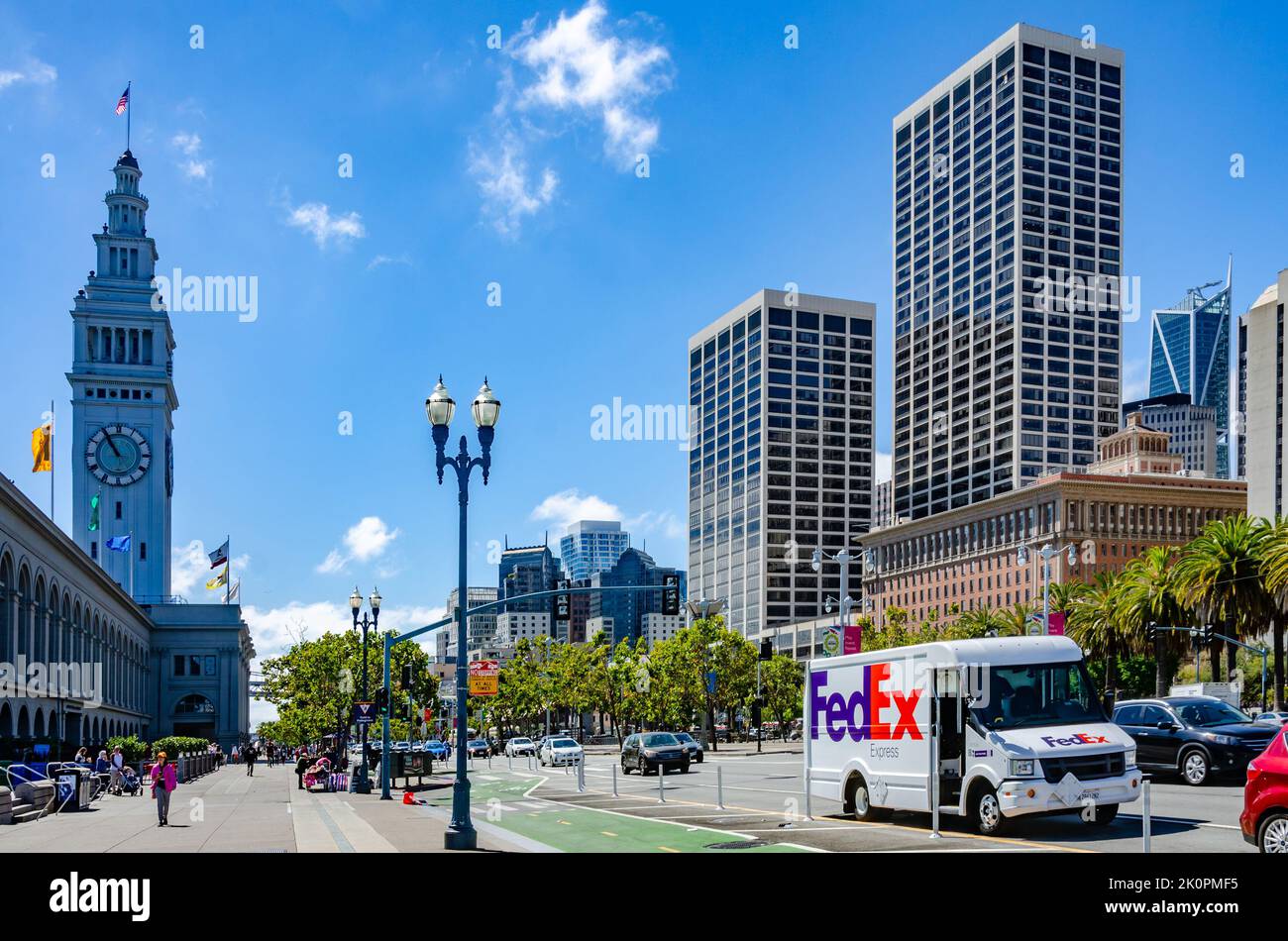 A view of Embarcadero in San Francisco on a dummer's day with blue sky and sunshine with One Market Plaza and The Ferry Port Clock Tower Stock Photo